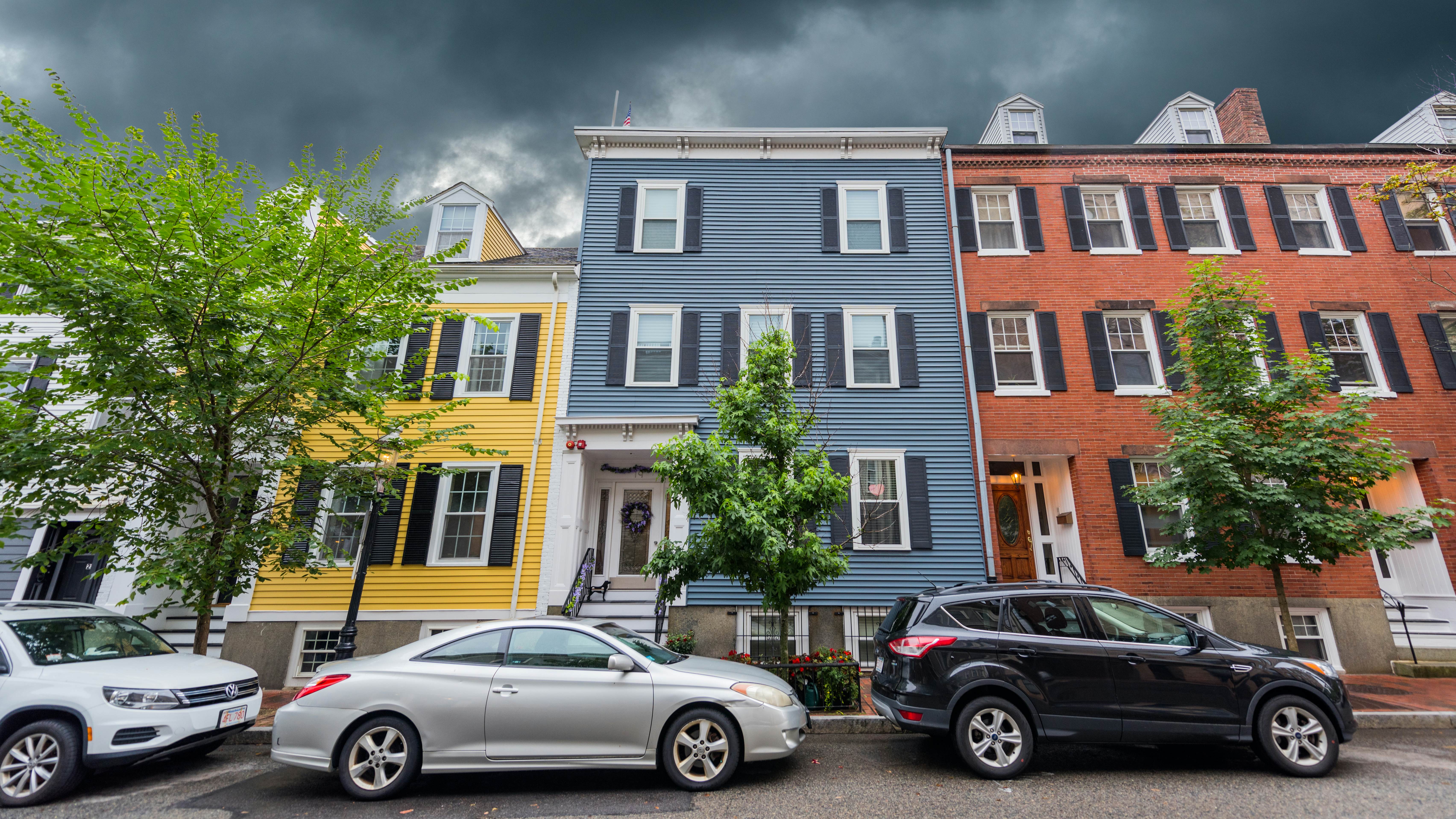 Boston, MA, USA - August 5, 2021: View of multi colored houses in Charlestown, Boston. Charlestown is the oldest neighborhood in Boston. Charlestown has many places of historical interest, some of which are included along the northern end of Boston's Freedom Trail.